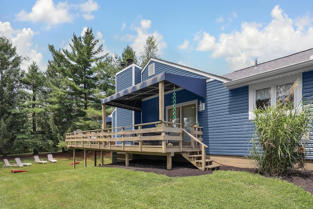 back of property with a yard and a wooden deck