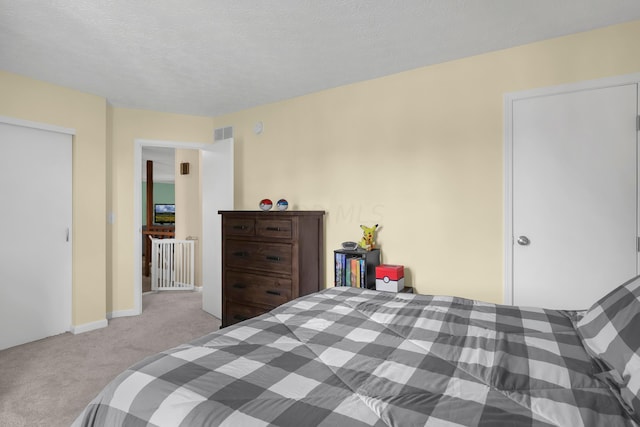 carpeted bedroom featuring a textured ceiling