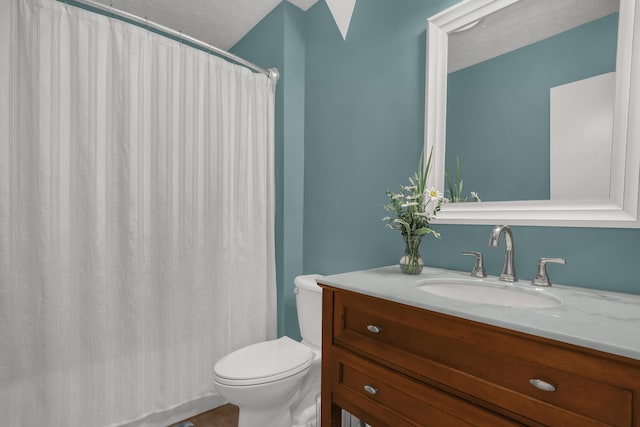 bathroom with vanity, a textured ceiling, and toilet