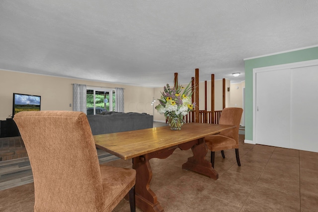 dining area with tile patterned flooring and a textured ceiling