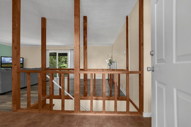 staircase with tile patterned flooring and a textured ceiling