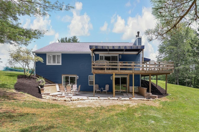 rear view of house with a yard, a deck, and a patio area