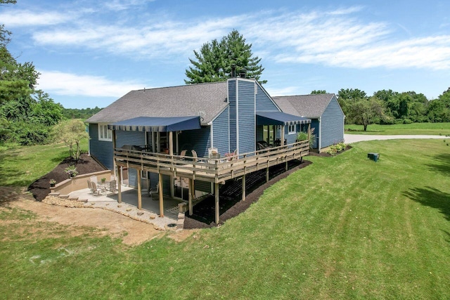 rear view of property with a patio area, a deck, and a yard