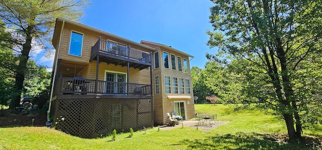 back of property with a balcony and a yard