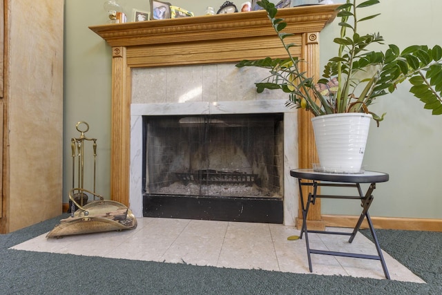 interior details featuring a fireplace and carpet floors