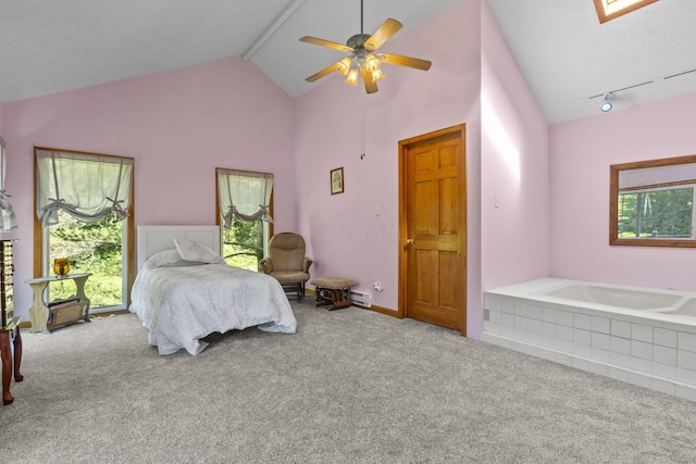 carpeted bedroom with ceiling fan, rail lighting, high vaulted ceiling, and multiple windows