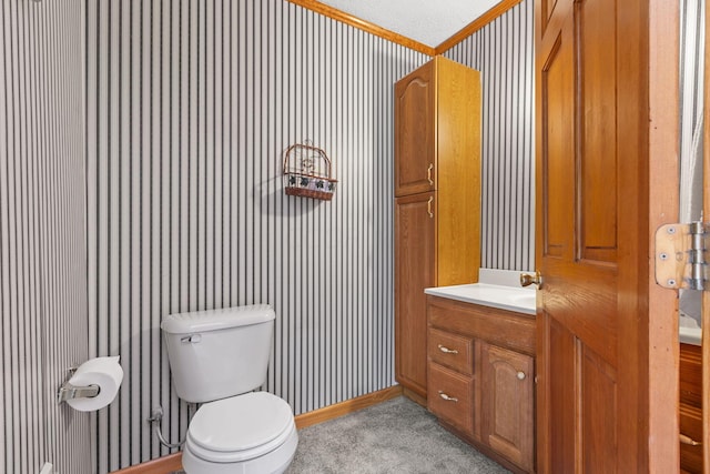 bathroom with vanity, a textured ceiling, and toilet