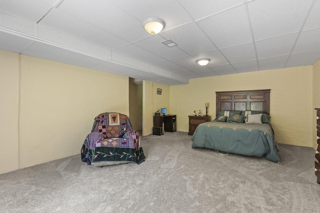 bedroom with carpet and a paneled ceiling