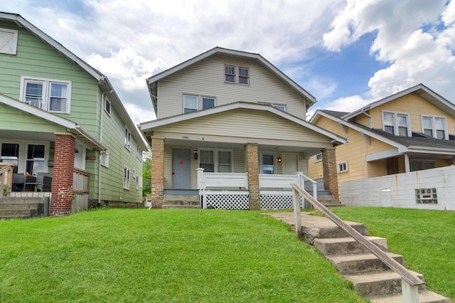 view of front of house with covered porch and a front lawn