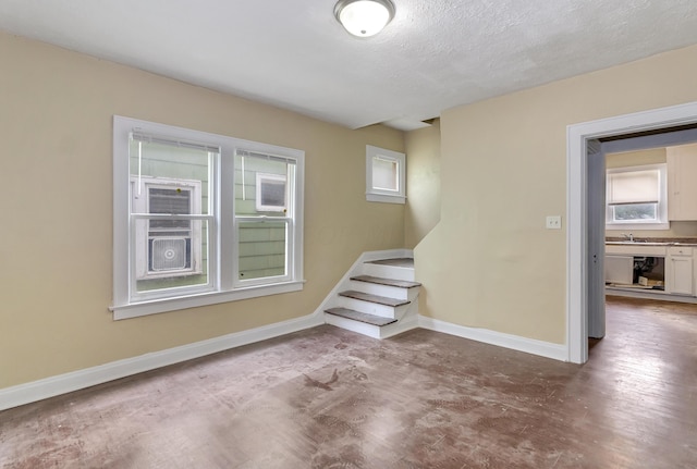 interior space featuring sink and a textured ceiling