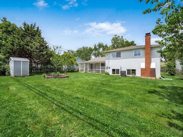 view of yard featuring a sunroom, cooling unit, and a shed