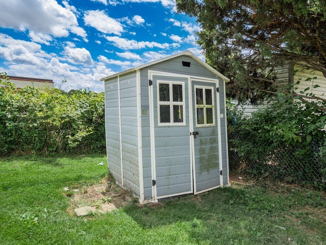 view of outdoor structure featuring a lawn