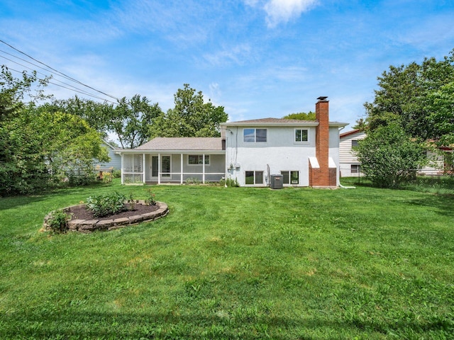 rear view of property featuring central AC, a lawn, and a sunroom