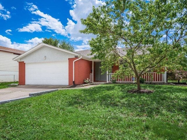 view of front of home with a garage and a front lawn