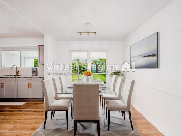 dining room featuring sink and light hardwood / wood-style flooring