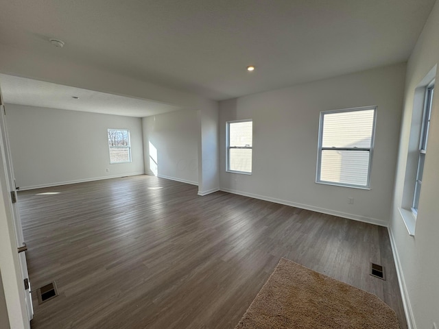 spare room featuring dark wood-type flooring