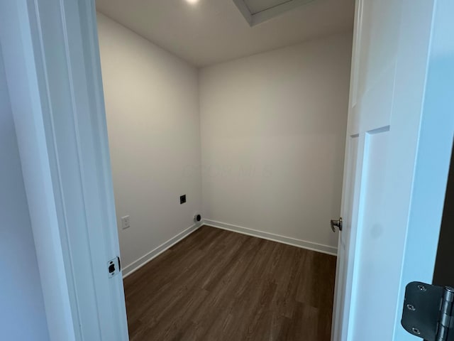 clothes washing area featuring electric dryer hookup and dark hardwood / wood-style flooring