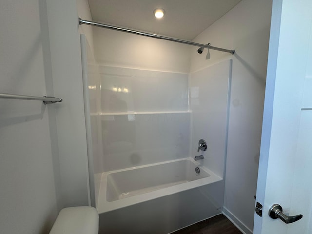 bathroom featuring shower / tub combination, toilet, and hardwood / wood-style floors