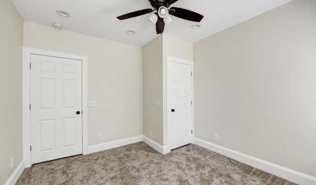 unfurnished bedroom with ceiling fan and light carpet