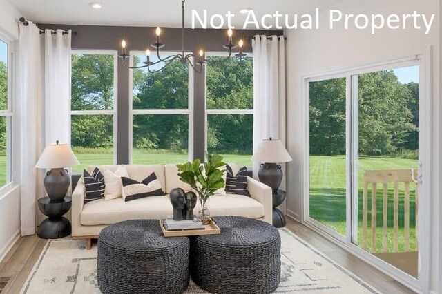 sunroom featuring a chandelier