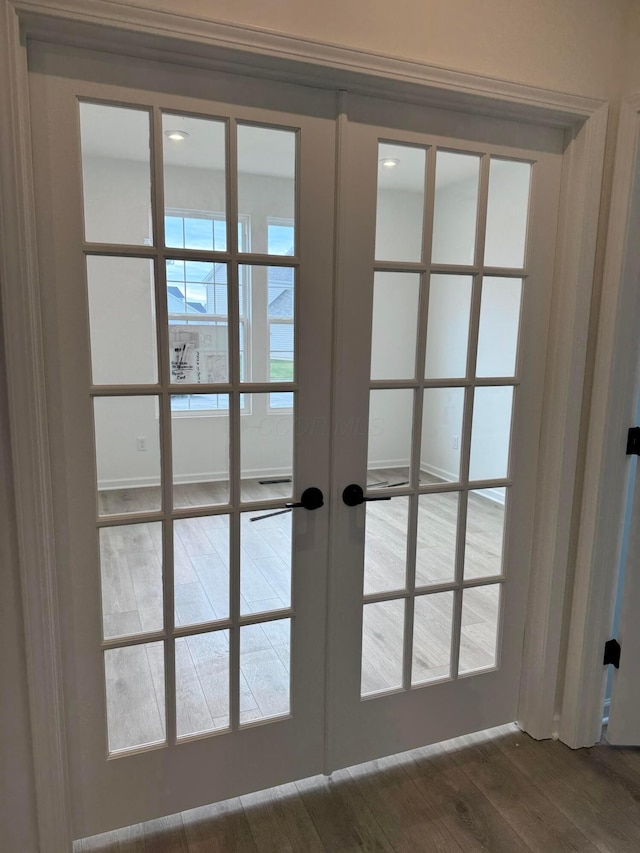 entryway with french doors and wood-type flooring