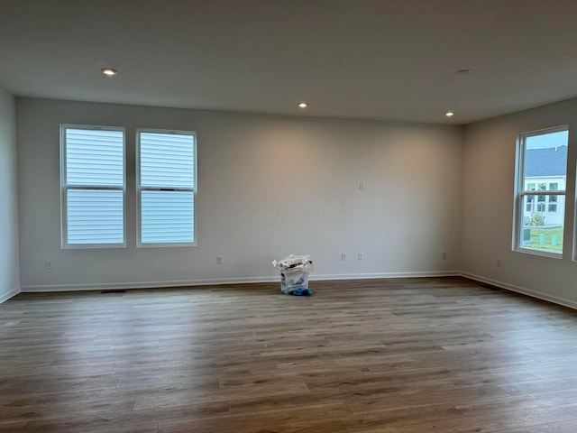 empty room with hardwood / wood-style flooring