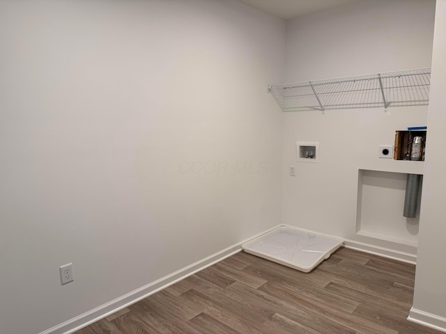 clothes washing area featuring hookup for an electric dryer, dark wood-type flooring, and washer hookup