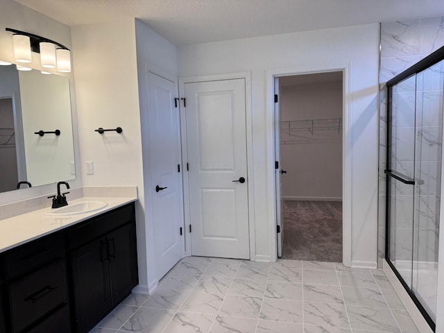 bathroom with vanity and a shower with door