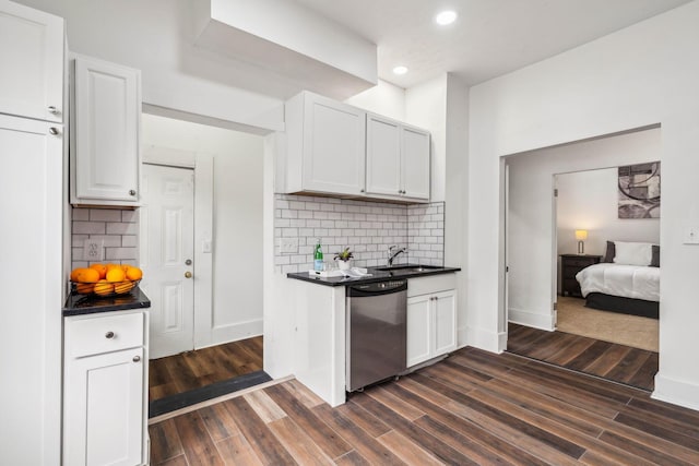 kitchen featuring white cabinets, dishwasher, decorative backsplash, and dark wood-type flooring