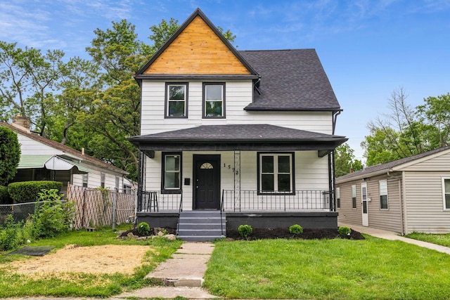 view of front facade with a front yard and a porch