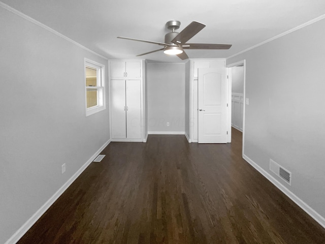 unfurnished bedroom with ceiling fan, dark wood-type flooring, and ornamental molding