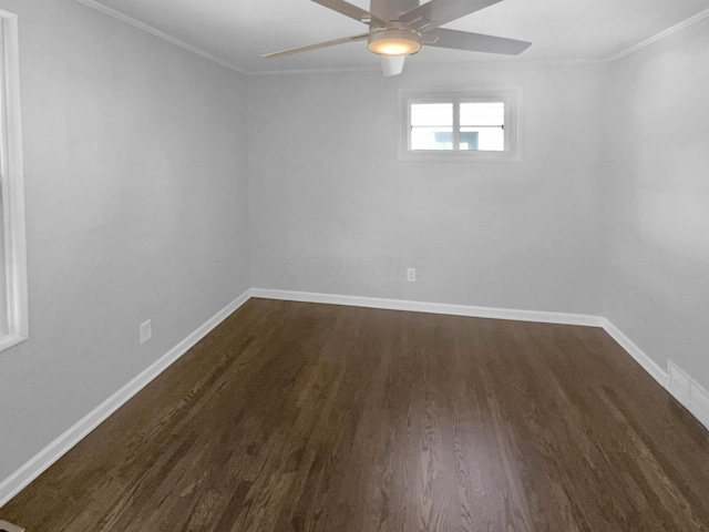 spare room featuring ceiling fan, ornamental molding, and dark wood-type flooring