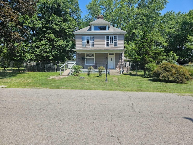 view of front facade featuring covered porch and a front yard