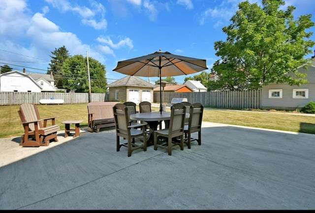 view of patio featuring an outbuilding and a garage