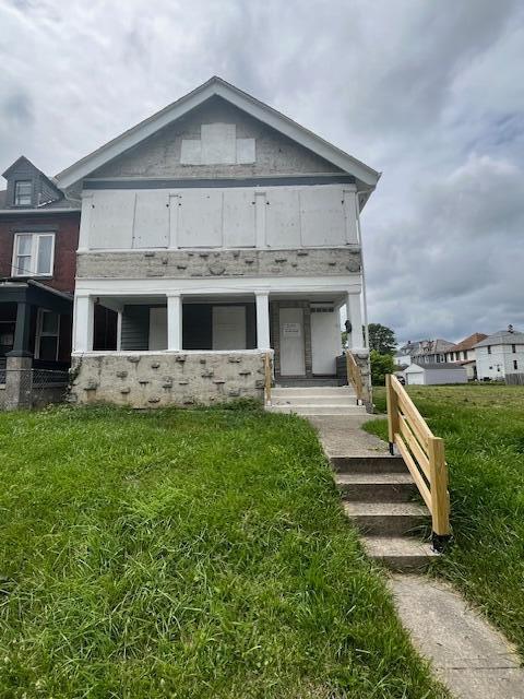 rear view of house with a yard