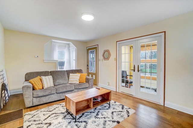 living room with french doors and wood-type flooring