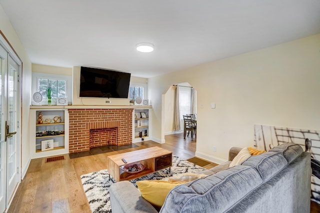 living room with hardwood / wood-style floors and a fireplace