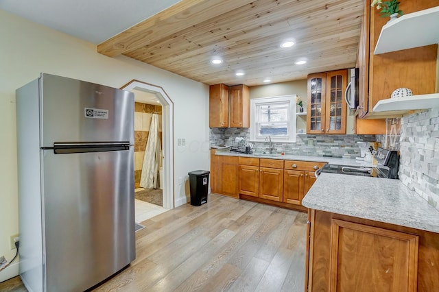 kitchen with appliances with stainless steel finishes, tasteful backsplash, sink, light hardwood / wood-style flooring, and wooden ceiling