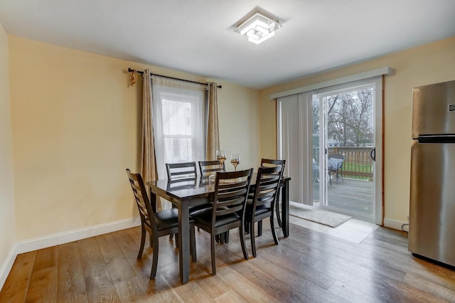 dining room featuring plenty of natural light and light hardwood / wood-style flooring