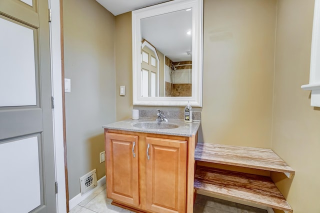 bathroom with tile patterned flooring and vanity