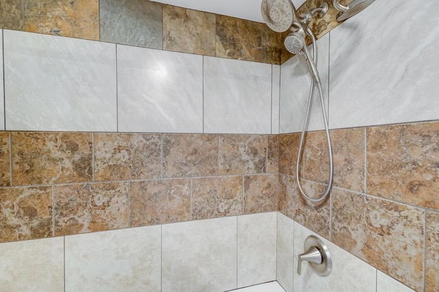 interior details with tiled shower / bath combo