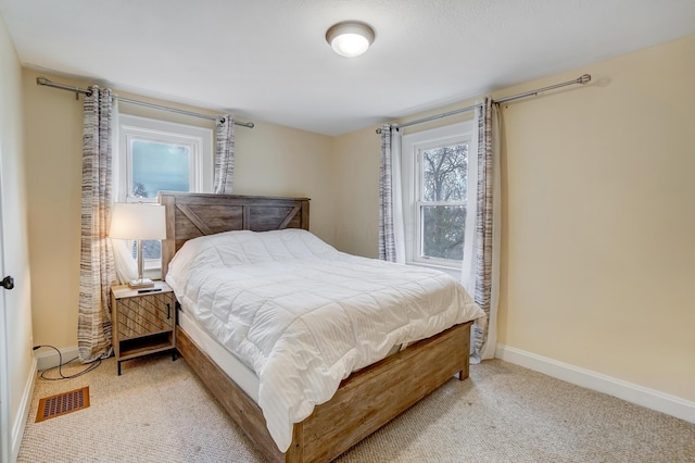 bedroom with light colored carpet