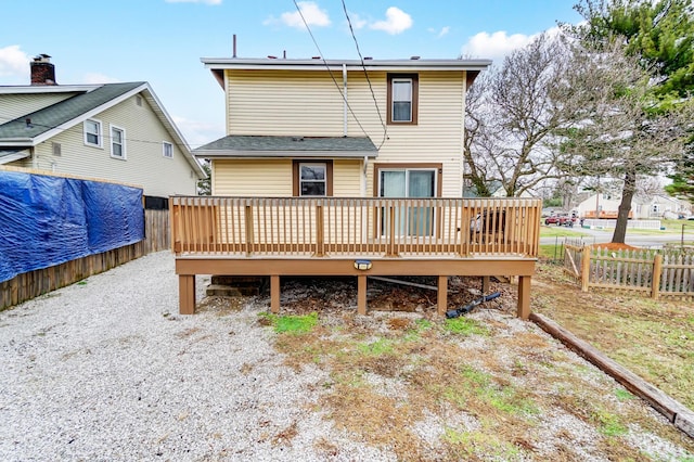 rear view of house featuring a wooden deck