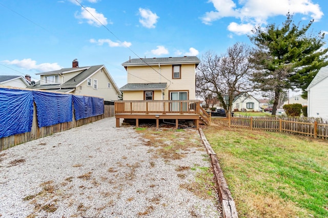 rear view of property with a lawn and a wooden deck