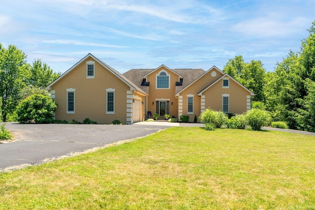 view of front of house with a garage and a front lawn