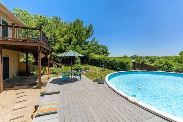 view of swimming pool with a wooden deck