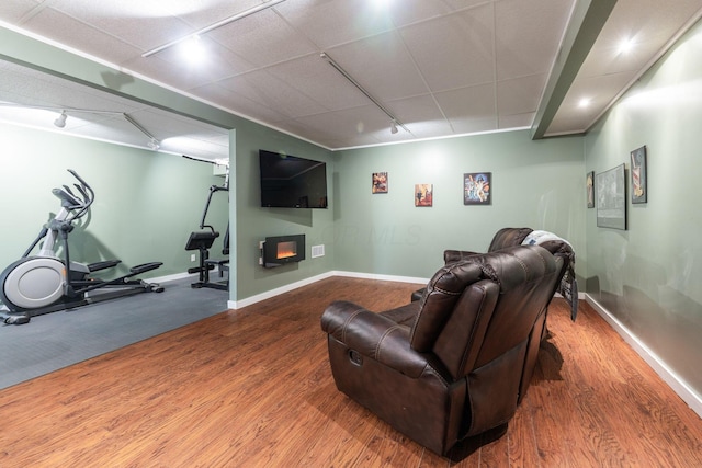 interior space with track lighting and hardwood / wood-style floors