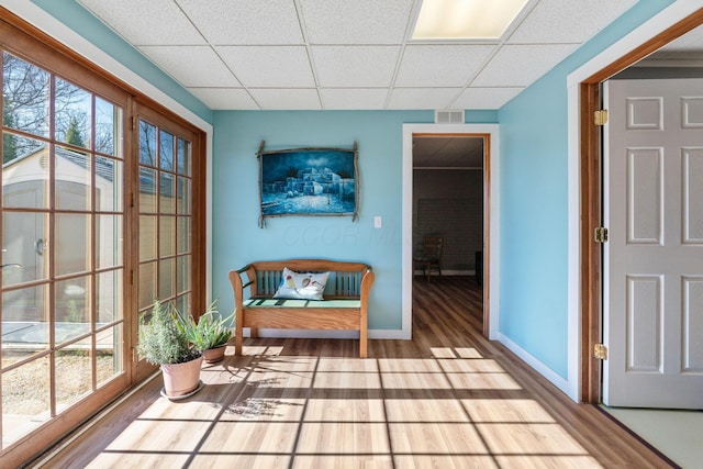 sitting room with a paneled ceiling and light hardwood / wood-style floors