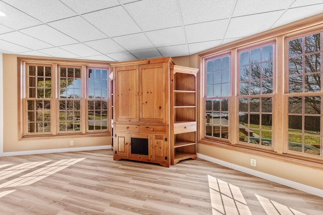 interior space with light hardwood / wood-style floors and a drop ceiling