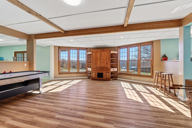 recreation room with a paneled ceiling and light hardwood / wood-style floors